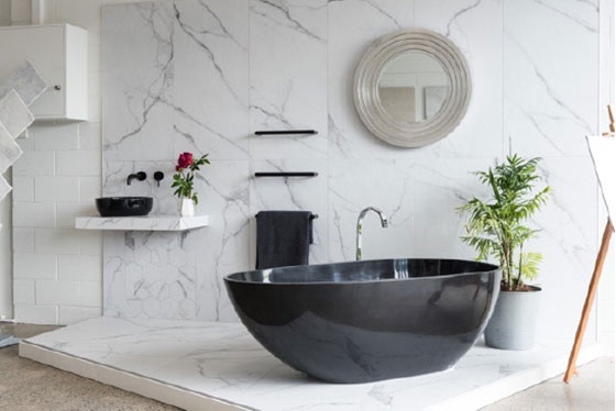 black sink in white tiled bathroom